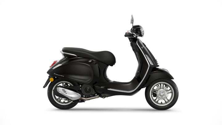 A sleek black scooter with a retro design, featuring a rounded body shape, a comfortable seat, and stylish chrome accents, displayed against a white background.