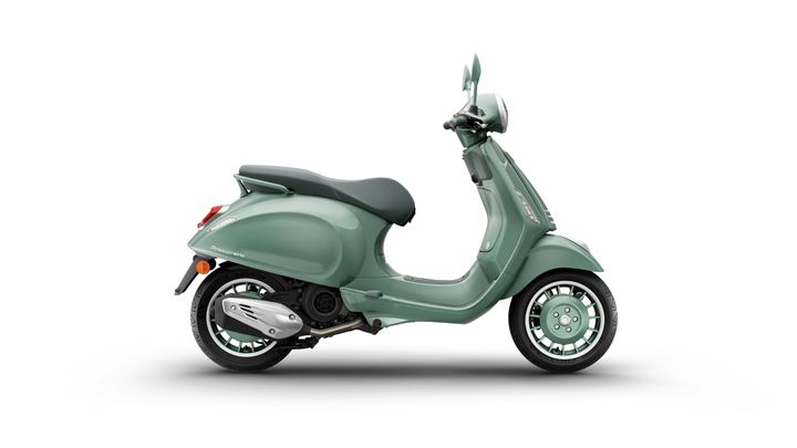 A mint green Vespa scooter displayed from the side, featuring a sleek design, black seat, and distinctive wheels.