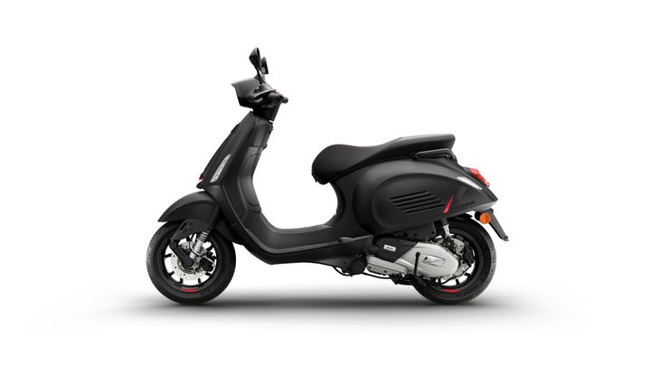 A sleek black scooter with a modern design, featuring a comfortable seat and a stylish side profile, parked on a white background.