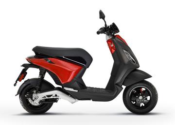 A modern red and black electric scooter against a white background.