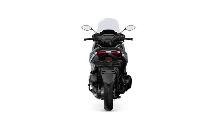 A rear view of a modern motorcycle with a sleek design, featuring a large windscreen, dual exhaust pipes, and prominent taillights. The motorcycle is positioned against a white background.