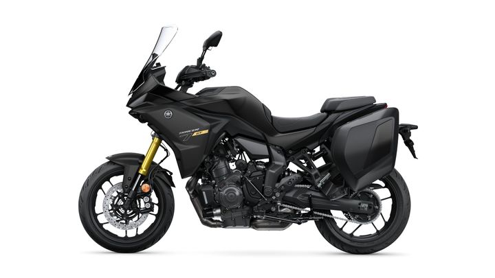 A sleek, black sport-touring motorcycle with a prominent windscreen, streamlined body, and integrated side panniers. The bike features gold front forks and is positioned on a white background.