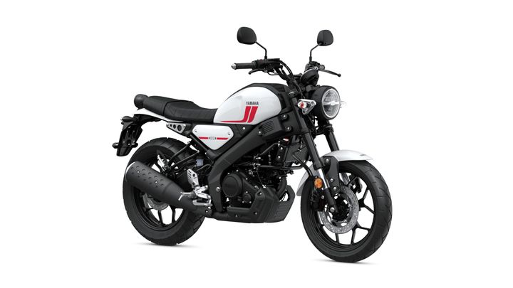 A stylish Yamaha motorcycle featuring a sleek white and black design, with a round headlight, low seat, and modern features, positioned against a plain background.