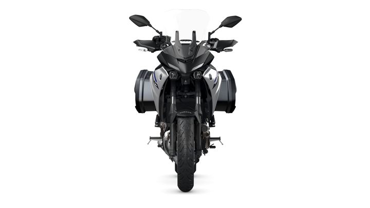 A front view of a sleek, modern motorcycle with a black and silver color scheme, equipped with side panniers and a tall windshield.