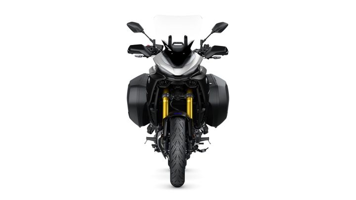Front view of a modern motorcycle with a sleek design, featuring a silver body, black side panniers, and gold front suspension forks. The motorcycle has a windscreen and dual mirrors, set against a white background.