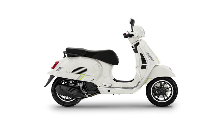 A white scooter with black accents, showcasing a sleek design and modern features, positioned on a plain white background.