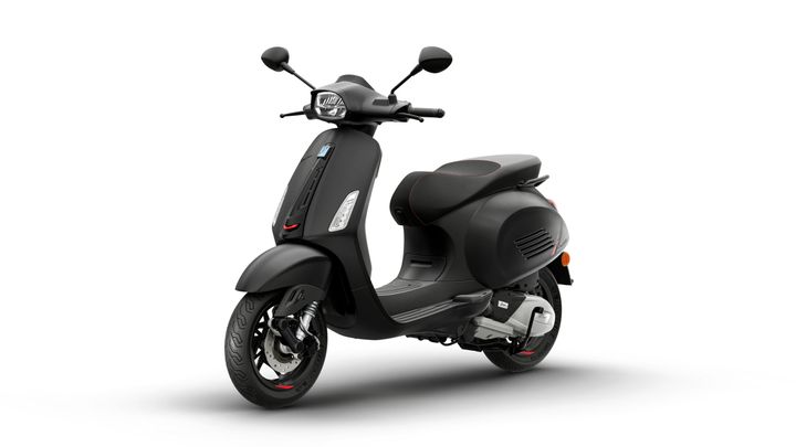 A sleek black scooter with a minimalist design, featuring a low seat, modern headlights, and red accents on the wheels and seat edges.