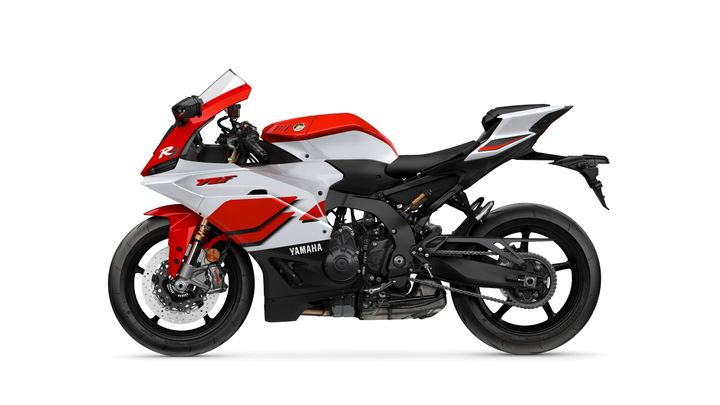 A sleek Yamaha YZF-R1 sport motorcycle in a red, white, and black color scheme, showcasing its aerodynamic design and detailed components side view.