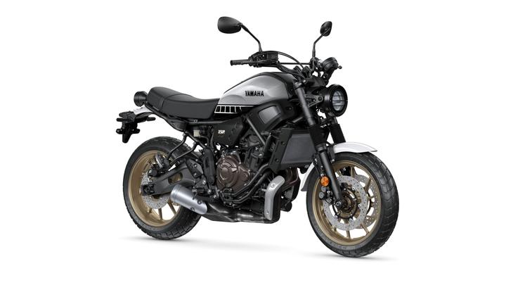 Yamaha 2023 XSR 700 Legacy motorcycle in metallic silver and black, featuring a minimalist design, round headlight, and gold-accented wheels.