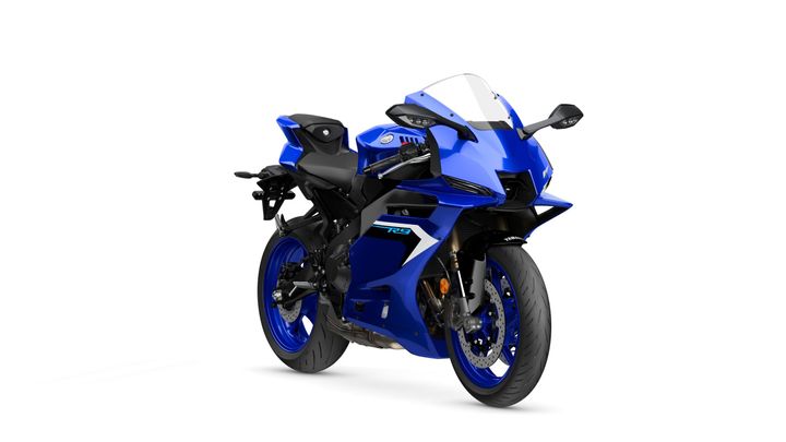 A blue sport motorcycle with a sleek design, featuring a prominent front fairing, dual headlights, and sporty seating, positioned at a slight angle to showcase its aerodynamic shape.
