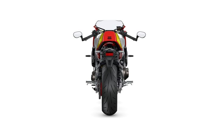 A rear view of a motorcycle featuring a colorful design, prominent exhaust, and a wide rear tire on a white background.