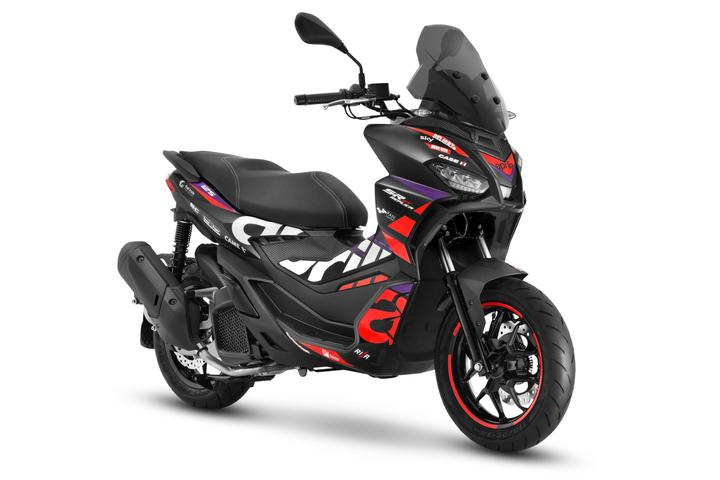 A black sporty scooter with red and purple graphics, featuring a windscreen, dual headlights, and black wheels with red trim on the tires, set against a white background.