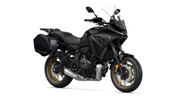 Yamaha 2024 Tracer 7 GT A black Yamaha motorcycle with gold rims, a transparent windscreen, and a side luggage compartment, displayed on a white background.