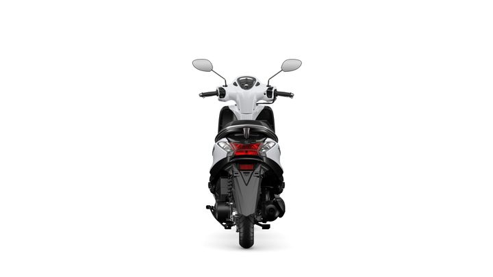 A rear view of a white scooter with a sleek design, featuring mirrors, a modern dashboard, and a visible tail light.