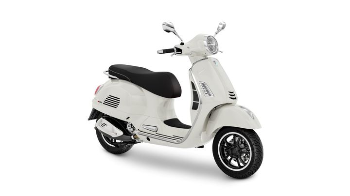 A sleek white scooter with a black seat, stylish design, and chrome accents, displayed in a three-quarter view.