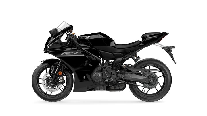A sleek black Yamaha YZF-R7 motorcycle viewed from the side, showcasing its sporty design, low profile, and modern features.