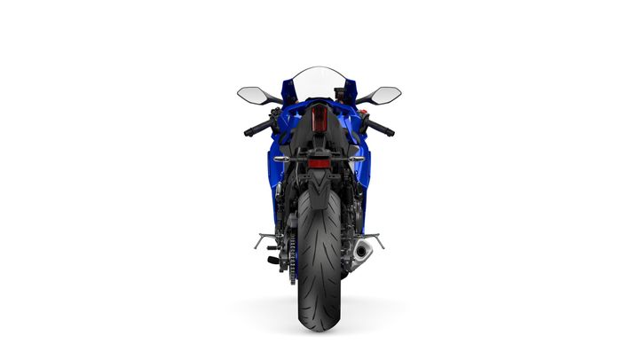 A motorcycle viewed from the rear, showcasing a blue body, dual exhaust, and thick rear tire, set against a white background.