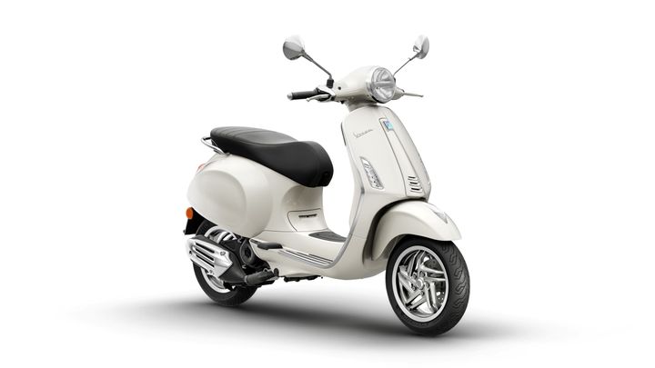 A stylish cream-colored scooter with a black seat, chrome accents, and a classic retro design, positioned on a white background.