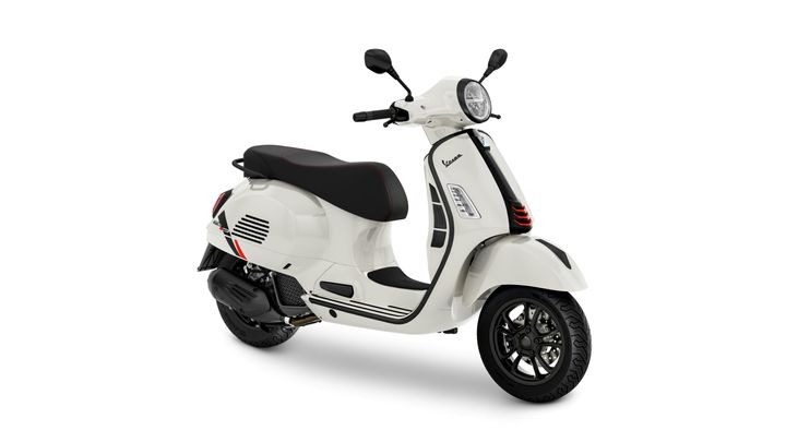 A sleek white scooter with a sporty design, featuring a black seat and accents, positioned at a slight angle to showcase its curves and modern styling.