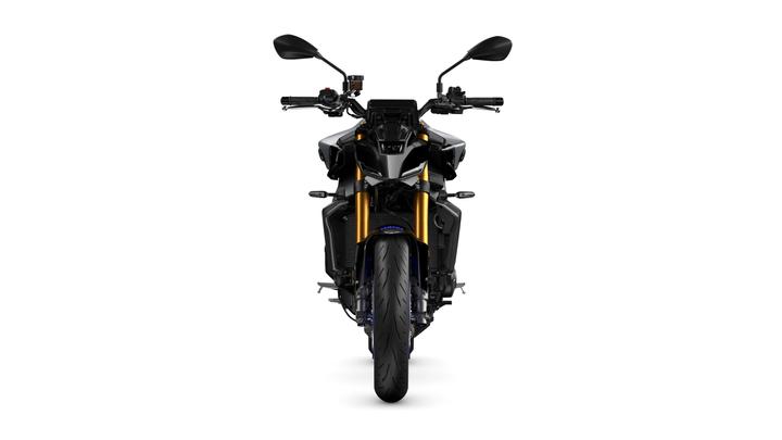 A front view of a modern sport motorcycle featuring a sleek design, prominent gold front forks, and black bodywork. The handlebars are equipped with mirrors and controls, with a large front tire visible below. The background is plain white, emphasizing the motorcycle's features.