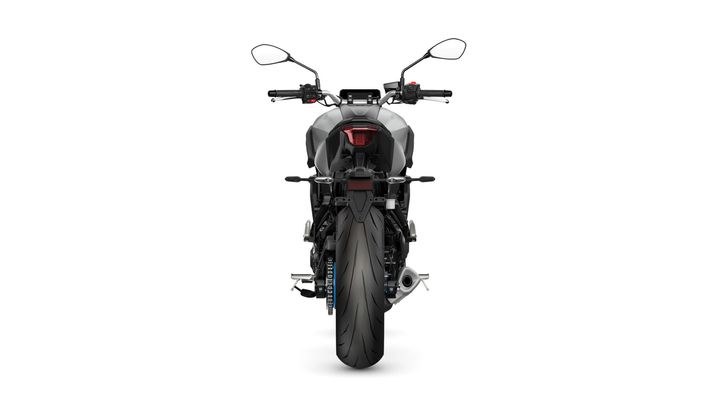 A rear view of a modern motorcycle showcasing its sleek design, prominent rear tire, and handlebars with mirrors. The motorcycle is set against a plain white background.