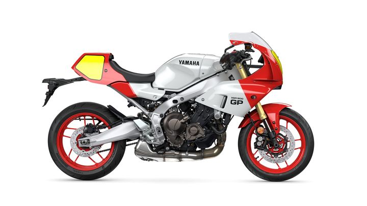 Side view of a Yamaha XSR900 GP motorcycle in a sleek silver and red color scheme, featuring distinctive fairings and modern styling.
