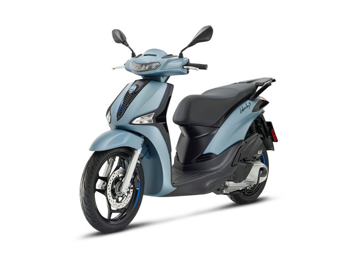 A sleek blue scooter with a modern design, featuring a comfortable black seat, front disc brake, and stylish headlights, positioned on a white background.