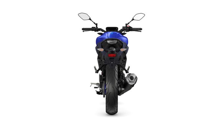 A blue motorcycle viewed from the rear, showcasing the rear wheel, exhaust, and handlebar controls.