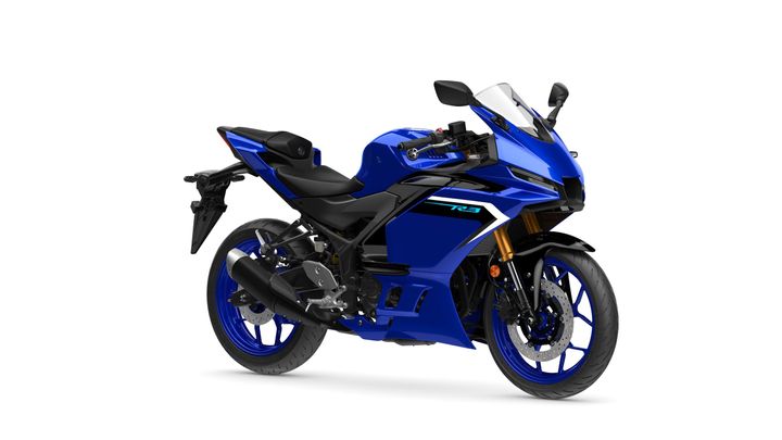 A blue sport motorcycle with a sleek design, featuring a fairing, windscreen, and sporty wheels, positioned at an angle to showcase its aerodynamic profile.