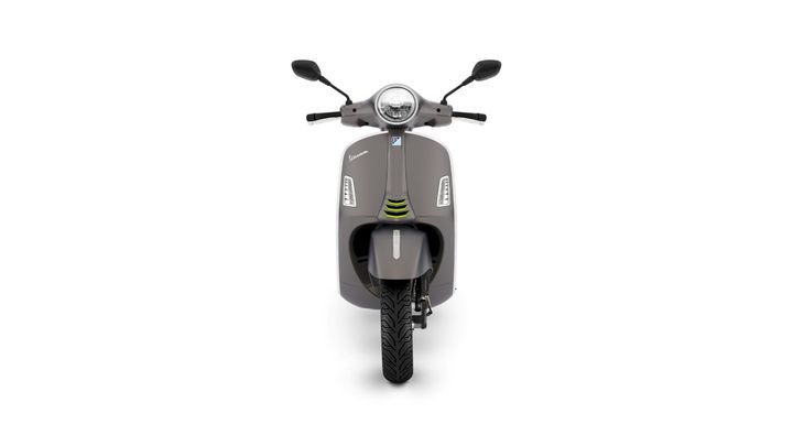 Front view of a modern gray scooter with a round headlight, two mirrors, and distinctive design elements, set against a white background.