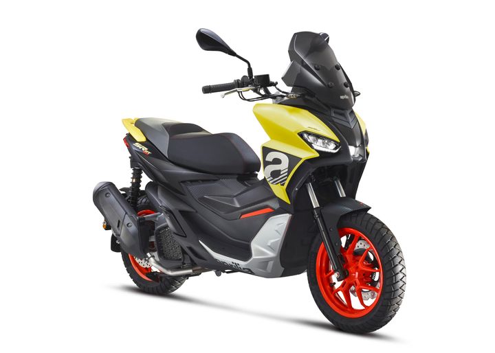 A modern scooter with a black and yellow color scheme, red wheels, and detailed bodywork, isolated on a white background.