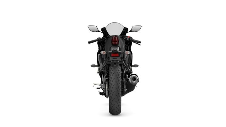 A rear view of a black motorcycle with a sleek design, featuring dual mirrors, a tail light, and a distinct rear tire tread pattern.
