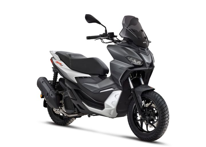 A modern gray scooter with black trim, dual-purpose tires, and a sporty design, isolated on a white background.