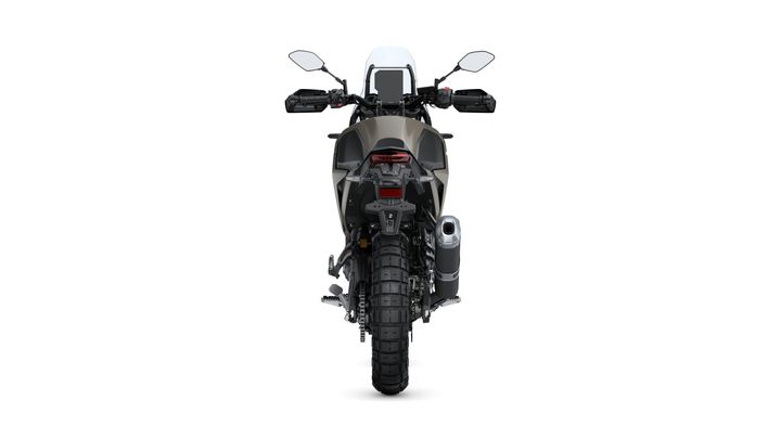 A rear view of a modern motorcycle with a rugged tire, dual rear lights, and a silver exhaust pipe, set against a plain white background.
