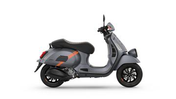 A modern gray scooter with orange accents, side view, featuring a stylish design and black wheels.
