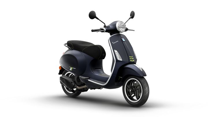 A sleek navy blue scooter with a black seat, featuring modern design elements and green accents, positioned at an angle against a white background.