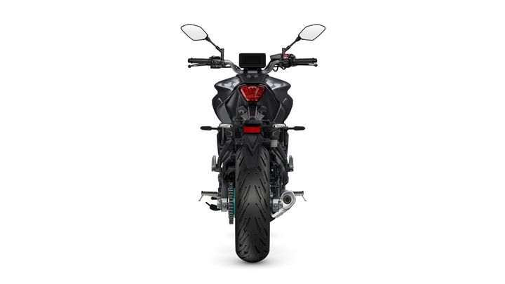 A rear view of a modern motorcycle showcasing its sleek design, features a prominent tire, dual rear mirrors, and a digital display on the handlebars.