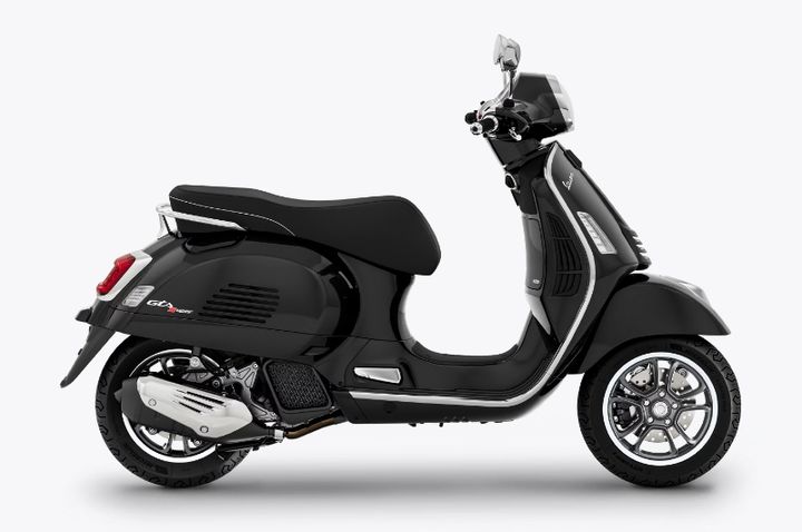 A black modern Vespa scooter with chrome details and a black seat, shot on a white background.