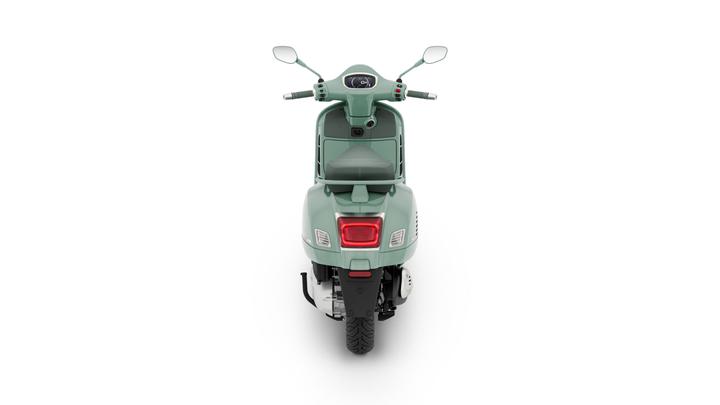 A mint green scooter viewed from the back, showcasing its sleek design, rear light, and the seat. The handlebars are visible with controls and mirrors on either side. The background is plain white.