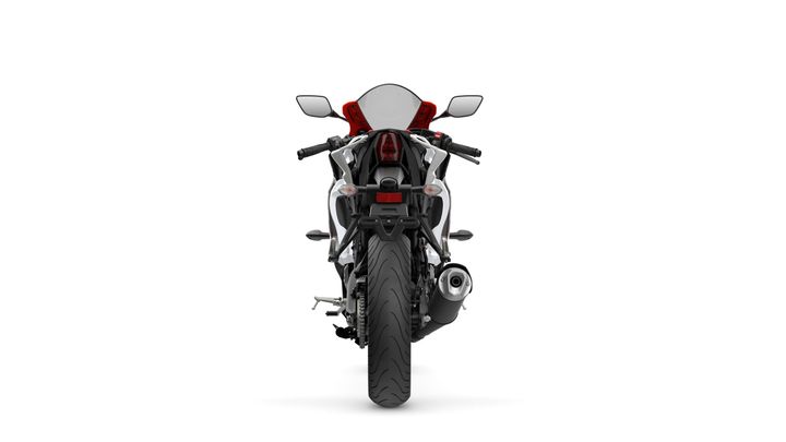 A rear view of a sleek motorcycle with a prominent tail light, a curved seat, and dual side mirrors. The motorcycle features a distinctive exhaust pipe and a detailed tire tread, set against a white background.
