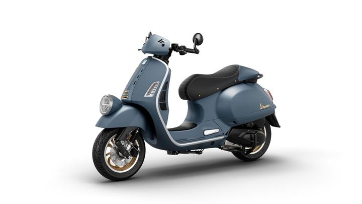 A stylish blue scooter with a black seat, featuring gold accents and a vintage design, positioned at a slight angle against a white background.