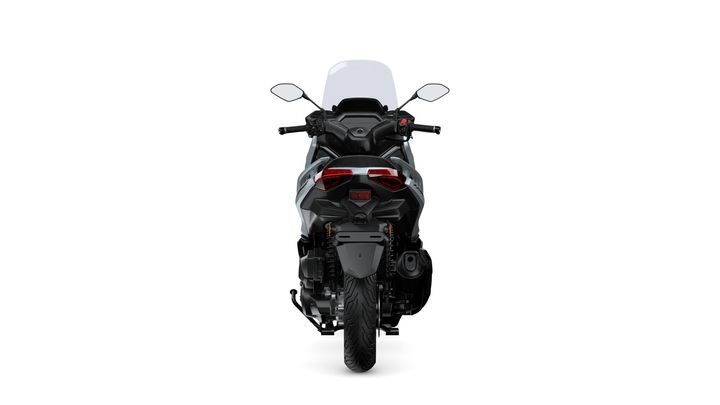 A rear view of a motorcycle with a prominent windshield, modern design, and reflective tail lights against a white background.