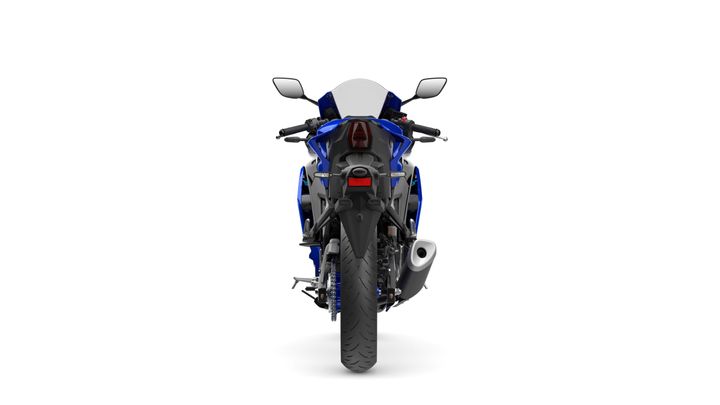 Rear view of a blue sports motorcycle, displaying the tail light, mirrors, and exhaust pipe against a white background.