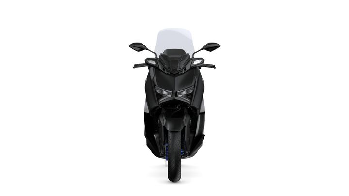A sleek black scooter with angular design, featuring prominent headlights and a transparent windscreen, viewed from the front.