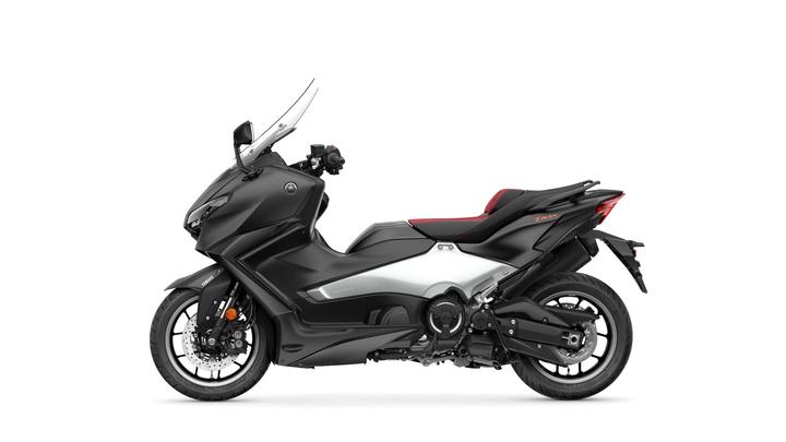 A sleek black and silver Yamaha TMAX scooter, featuring a sporty design, windscreen, and a red-accented seat, shown from the side against a white background.