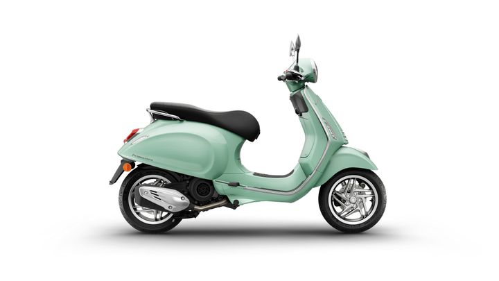 A mint green scooter with a black seat, shown in profile against a white background. The scooter features chrome accents, a round headlight, and stylish wheels.