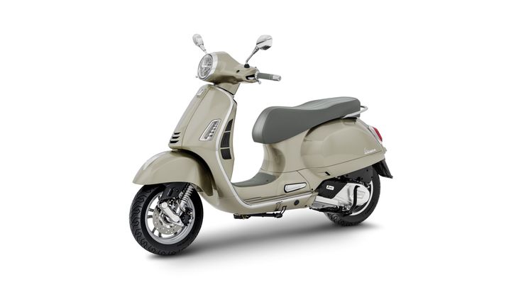 A beige scooter with a gray seat, shown from the side, featuring a classic design, chrome accents, and a vintage look.