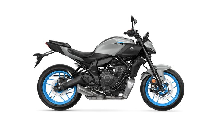 A sleek, modern motorcycle in matte gray with vibrant blue wheels, showcasing a minimalist design and exposed engine components.