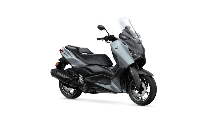 A sleek, modern scooter with a silver and black color scheme, featuring a tall windscreen, comfortable seating, and prominent Yamaha branding. The scooter is displayed at a slight angle, showcasing its stylish design and sporty details.