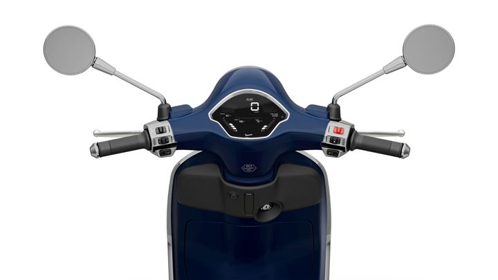 Front view of a blue scooter's handlebars, featuring mirrors, a digital speedometer, and control switches.